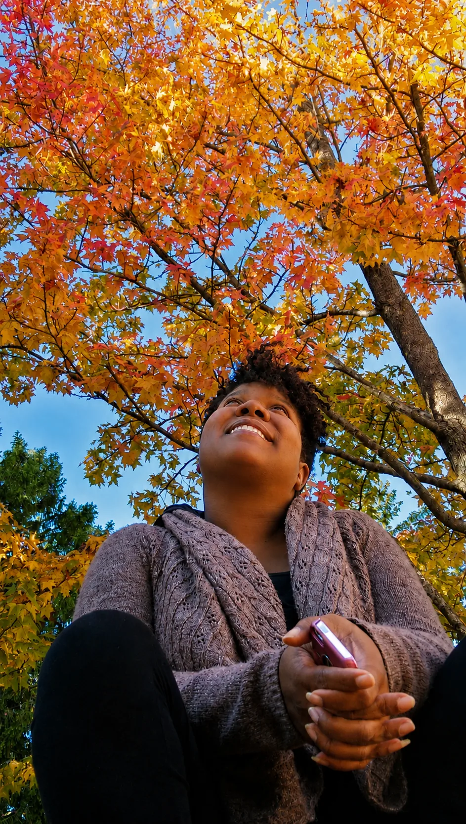 Dori LeGrand-Christmas smiling beneath colorful autumn trees