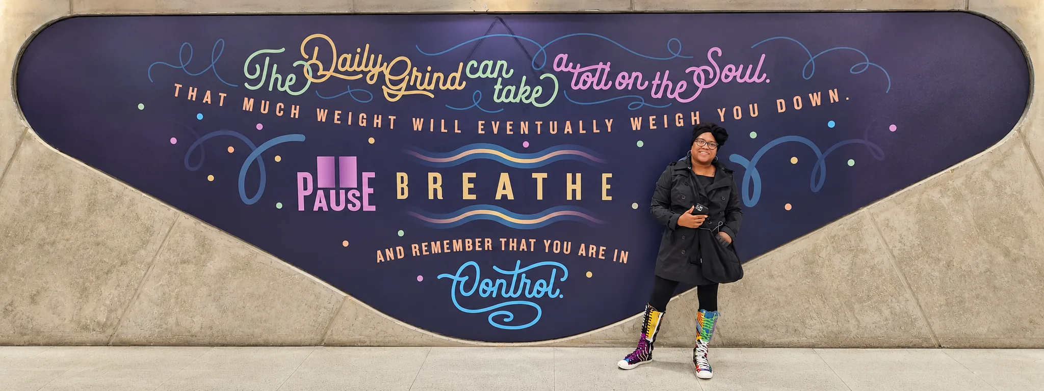 Clinical supervision with Dori LeGrand-Christmas beside a colorful Pause Breathe mural
